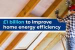 £1 Billion to improve home energy efficiency. A builder installing roof insulation.